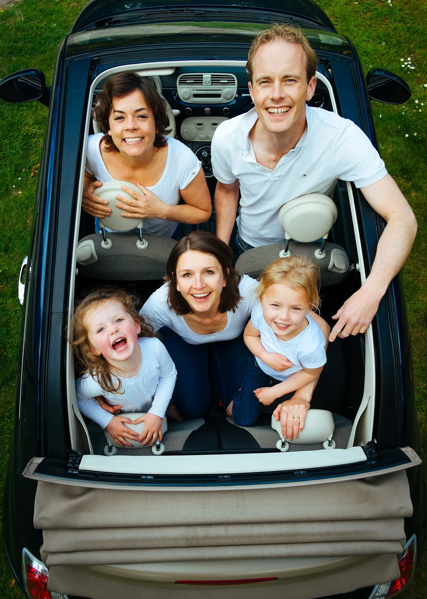 An arial view of a happy family in a car